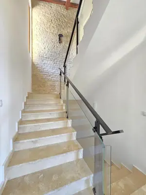 a staircase with white walls and a brick wall at Villa Trend, Budva, Kuljače in Budva