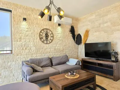a living room with a couch and a tv at Villa Trend, Budva, Kuljače in Budva