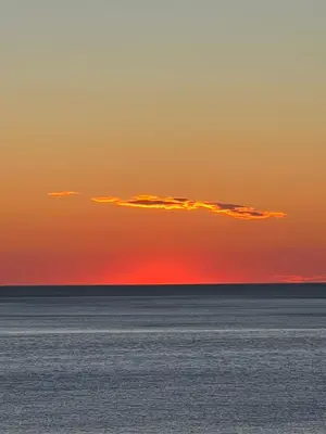 a sunset over the ocean with a cloud in the sky at Sea view in Petrovac na Moru