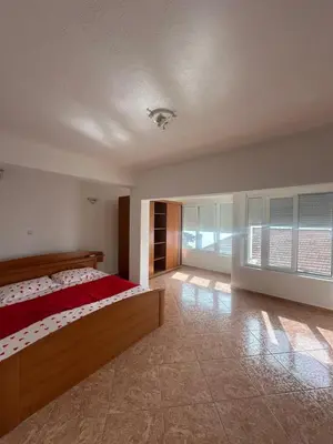 a bedroom with a bed and a large window at Marija 2 Apartman in Ulcinj
