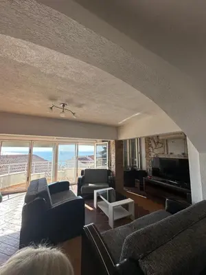 a living room with couches and a view of the ocean at Marija 2 Apartman in Ulcinj