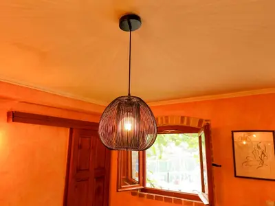 a pendant light hanging from a ceiling with a window at Panoramic view ! Rooftop garden - Old Town studio in Kotor