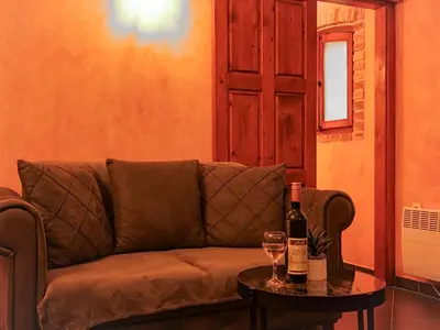 a couch with a table and two glasses of wine at Panoramic view ! Rooftop garden - Old Town studio in Kotor