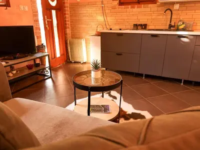 a living room with a table and a kitchen at Panoramic view ! Rooftop garden - Old Town studio in Kotor