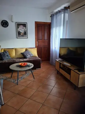a living room with a couch and a flat screen tv at Romantic Escape - Stunning Rooftop Views - Old Town in Kotor