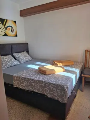 a bedroom with a bed with two towels on it at Romantic Escape - Stunning Rooftop Views - Old Town in Kotor