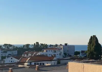 a view of a city with houses and the ocean at Vila Dube in Ulcinj