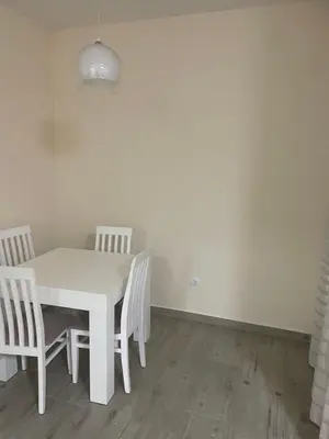 a white table and chairs in a room at Leilighet i ulcinj in Ulcinj