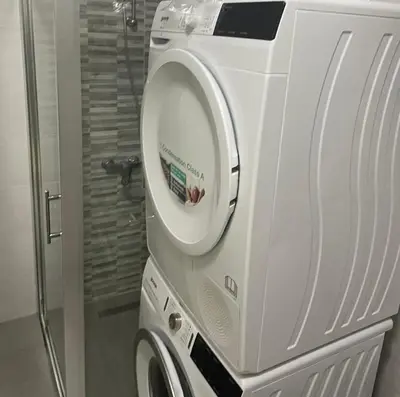 a white washer and dryer in a bathroom at Leilighet i ulcinj in Ulcinj