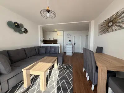 a living room with a couch and a wooden table at Apartment Alex in Dobra Voda