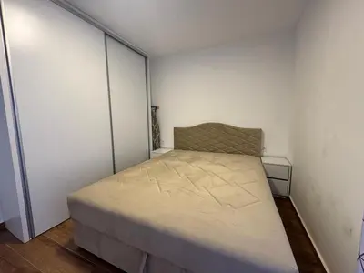 a small bedroom with a bed in the corner at Apartment Alex in Dobra Voda