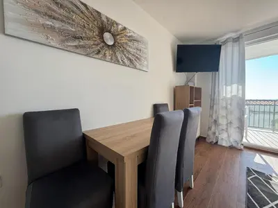 a dining room with a wooden table and chairs at Apartment Alex in Dobra Voda