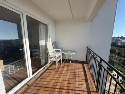 a balcony with a glass table and chairs on it at Apartment Alex in Dobra Voda