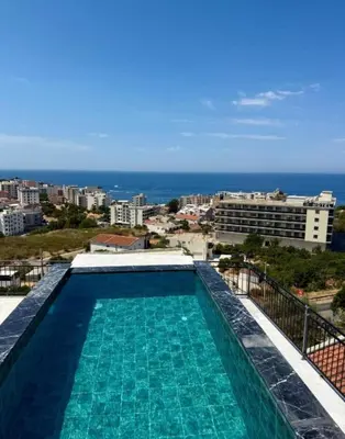 a swimming pool with a view of the ocean at Apartment Alex in Dobra Voda