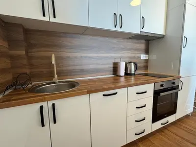 a kitchen with white cabinets and a sink at Apartment Alex in Dobra Voda