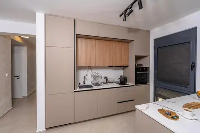 a kitchen with white cabinets and a counter top at Wave Apartments - Dobra Voda in Bar