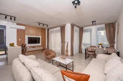 a living room with a couch and a table at Wave Apartments - Dobra Voda in Bar