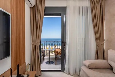 a living room with a view of the ocean at Wave Apartments - Dobra Voda in Bar