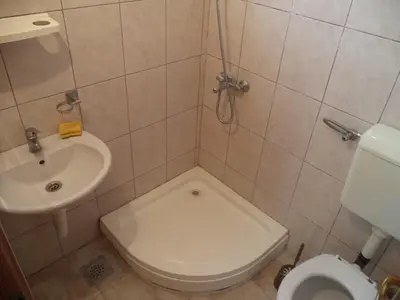a small bathroom with a toilet and a sink at Vito Apartments Sutomore in Sutomore