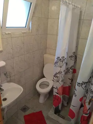 a bathroom with a toilet and a sink at Vito Apartments Sutomore in Sutomore