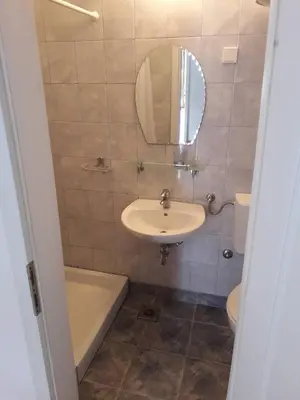 a bathroom with a sink and a tub and a mirror at Apartments Markovic Sutomore in Sutomore