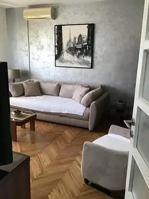 a living room with a white couch in a room at BMB Apartments Kotor in Kotor