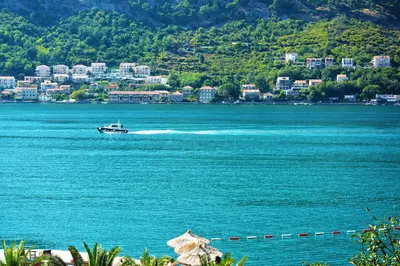 a boat on a large body of water at BMB Apartments Kotor in Kotor