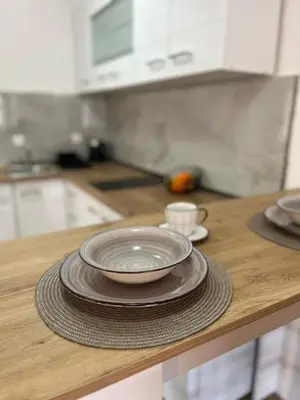 a stack of plates sitting on a counter in a kitchen at Apartment Stari Konak in Virpazar