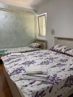 a bedroom with two beds with towels on them at Villa Rezevici in Katun
