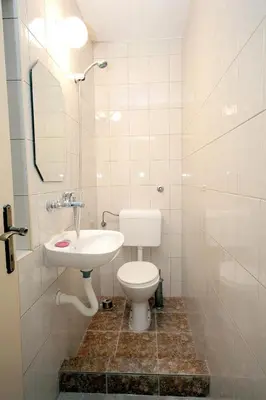 a bathroom with a toilet and a sink at Villa Rezevici in Katun