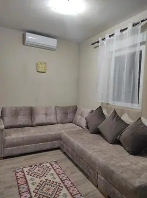 a brown couch in a living room with a window at Tanla in Danilovgrad