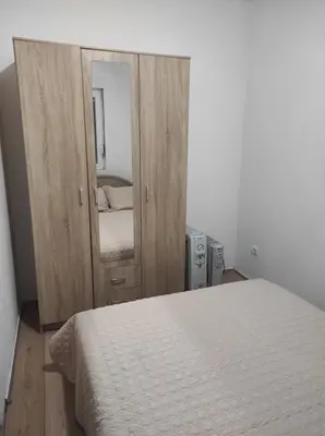 a bedroom with a white bed and a mirror at Tanla in Danilovgrad