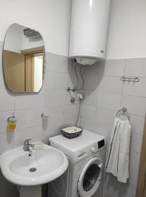 a bathroom with a washing machine and a sink at Tanla in Danilovgrad