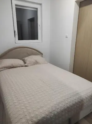 a bedroom with a bed with a mirror on the wall at Tanla in Danilovgrad