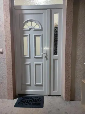a white door with a welcome mat in front of it at Tanla in Danilovgrad
