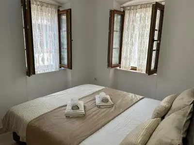 a bedroom with a bed with two towels on it at Apartment Marko in Kotor