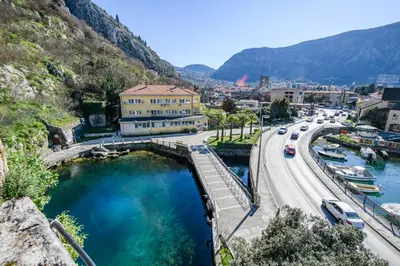 a bridge over a river next to a road at Apartment Marko in Kotor