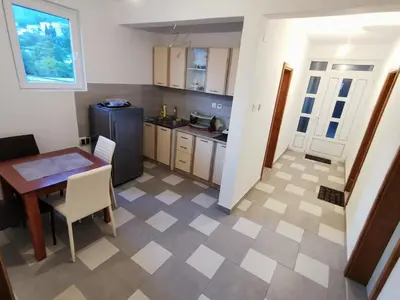 a kitchen with a table and a dining room at Stan Daria in Sutomore