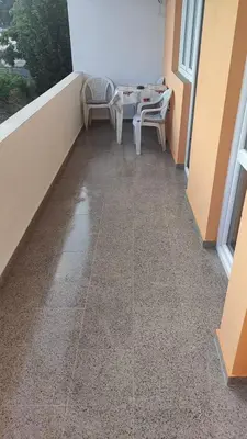 a balcony with a table and chairs in a room at Stan Daria in Sutomore