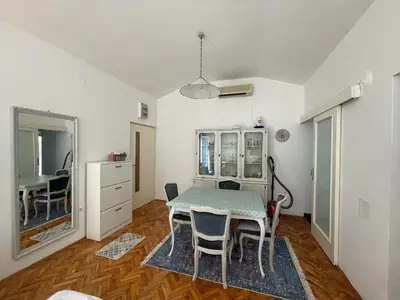 a kitchen and dining room with a table and chairs at Nikola's apartment in Budva
