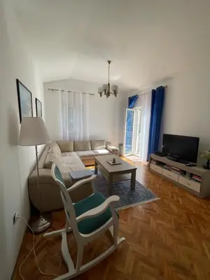 a living room with a couch and a table at Nikola's apartment in Budva