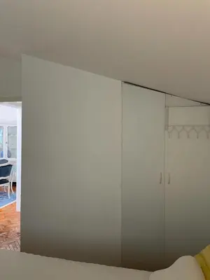 a large white cabinet in a living room at Nikola's apartment in Budva