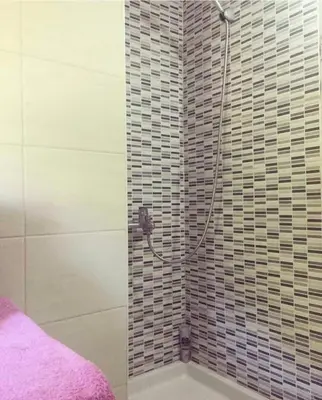 a shower in a bathroom with a tile wall at Nikola's apartment in Budva