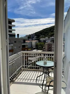 a balcony with a table and a view of a city at Nikola's apartment in Budva