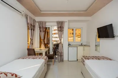 a hotel room with two beds and a kitchen at Ponte di Ferro in Budva