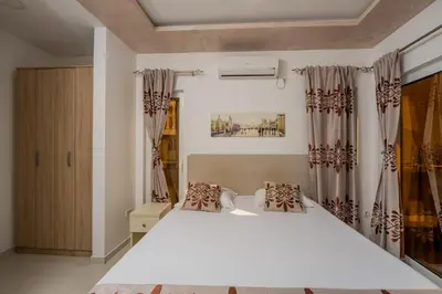 a bedroom with a large white bed with curtains at Ponte di Ferro in Budva