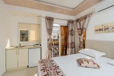 a bedroom with a bed and a sink in it at Ponte di Ferro in Budva