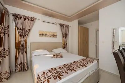 a bedroom with a large bed with curtains at Ponte di Ferro in Budva