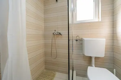 a bathroom with a shower with a toilet at Ponte di Ferro in Budva