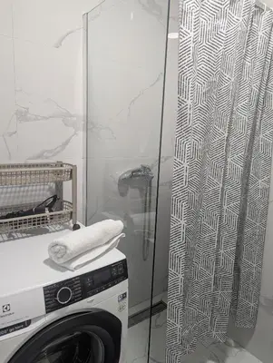 a washing machine in a bathroom with a shower at Podgorica Zabjelo titex 3 in Podgorica